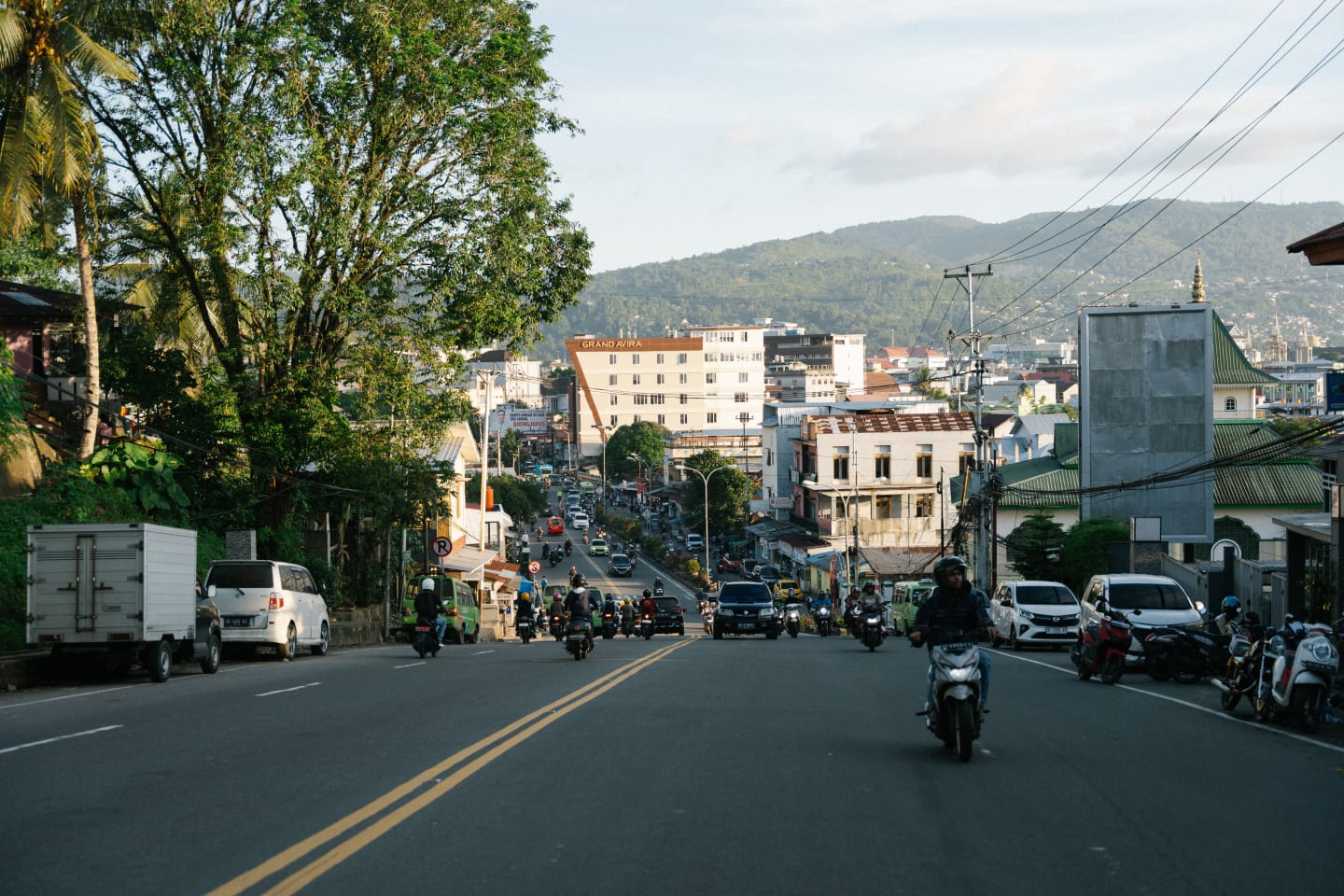 A busy hillside street in a Southeast Asian town
